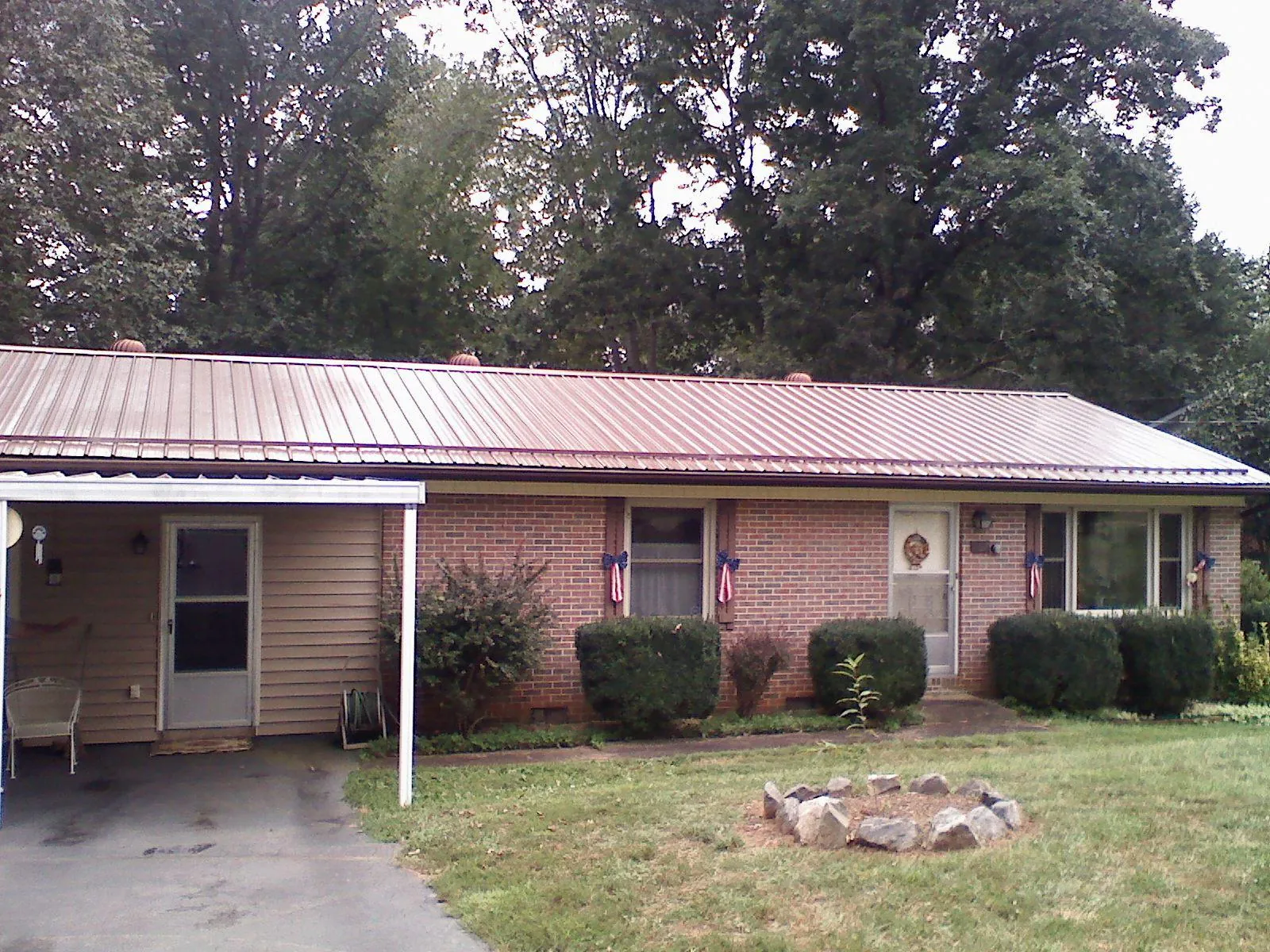 Bronze metal roof and carport on a brick ranch home — Roof Repair work by our crew in New Church
